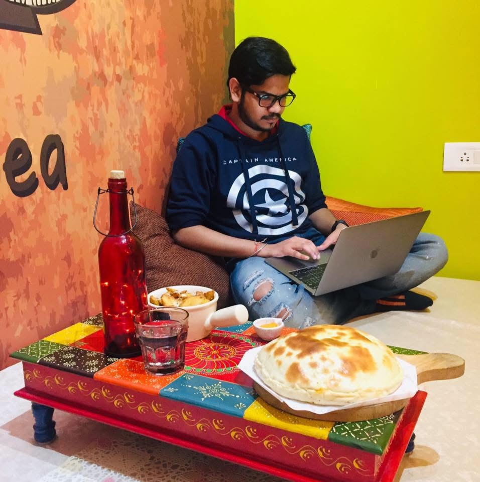 Satvik working on a laptop in a cafe